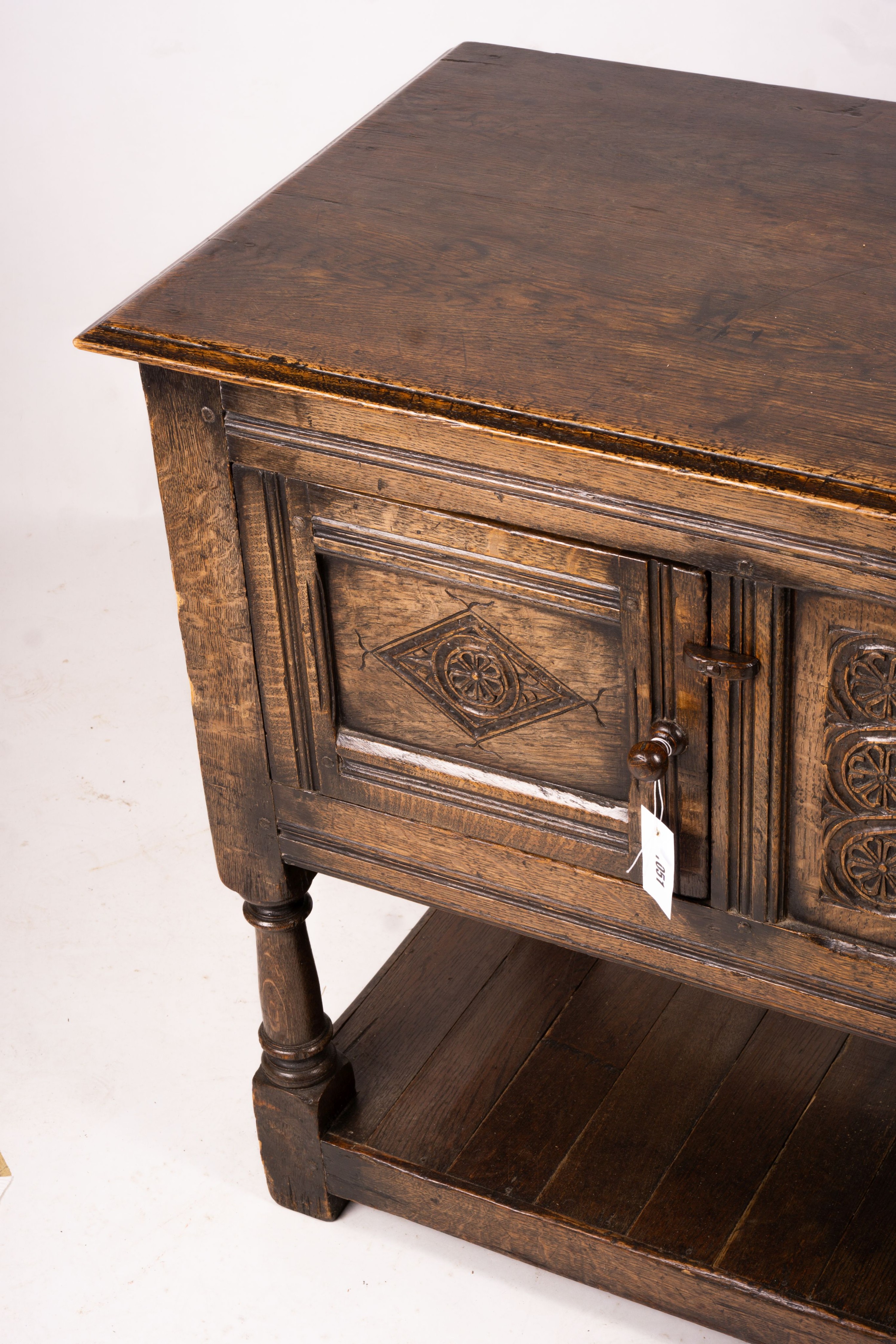 An 18th century style oak two door low cupboard, width 106cm, depth 50cm, height 78cm